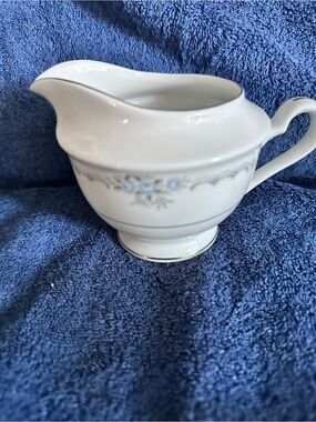 Elegant White Porcelain Creamer with Blue Floral Accent